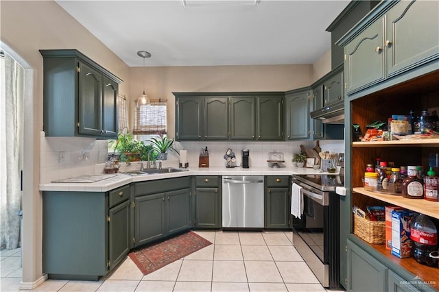 1602 Meadow Ln, Harlingen, TX 78550 - kitchen featuring appliances with stainless steel finishes, a sink, decorative backsplash, light tile patterned flooring, and under cabinet range hood