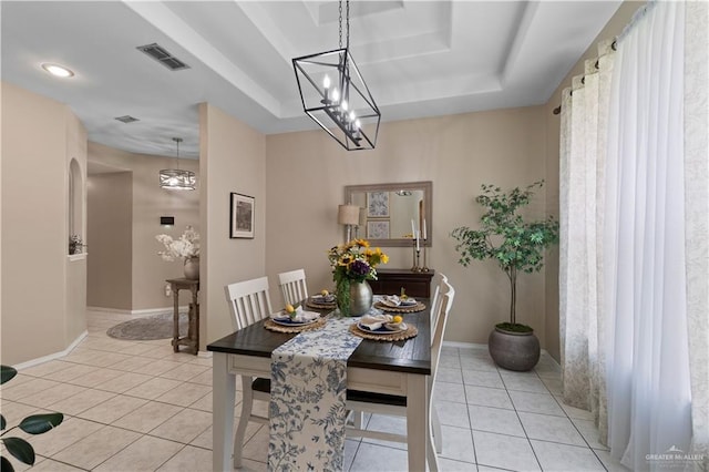 1602 Meadow Ln, Harlingen, TX 78550 - dining space with a raised ceiling, light tile patterned floors, baseboards, and a chandelier