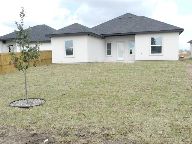 back of house featuring a lawn