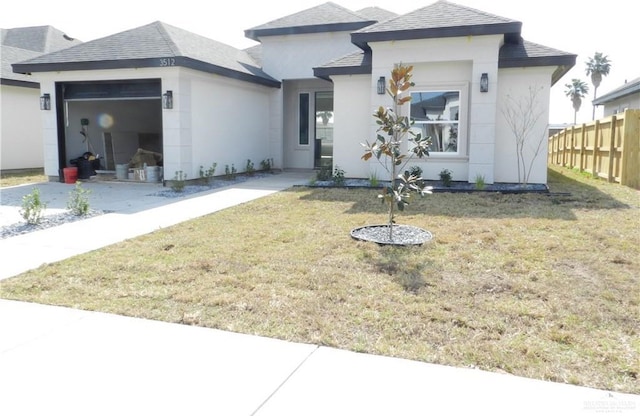 prairie-style house featuring a front lawn and a garage