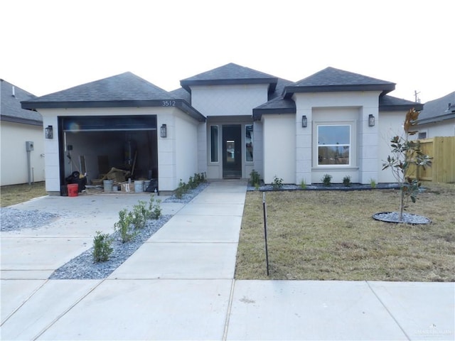 view of front of property with a garage and a front lawn