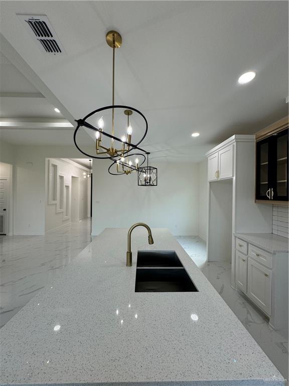 805 E Costa Del Sol Ave, Edinburg, TX 78542 - kitchen featuring light stone countertops, recessed lighting, decorative light fixtures, visible vents, and a sink