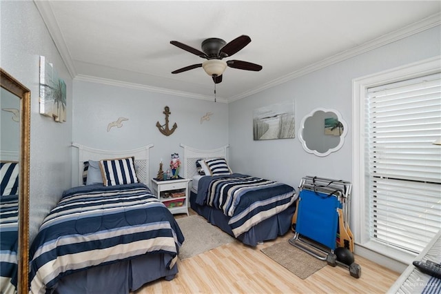 bedroom with hardwood / wood-style floors, ceiling fan, and ornamental molding