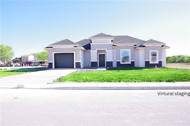 prairie-style house featuring a garage, stucco siding, concrete driveway, and a front yard