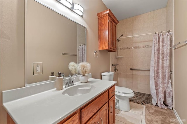 bathroom featuring tiled shower, vanity, toilet, and tile patterned flooring