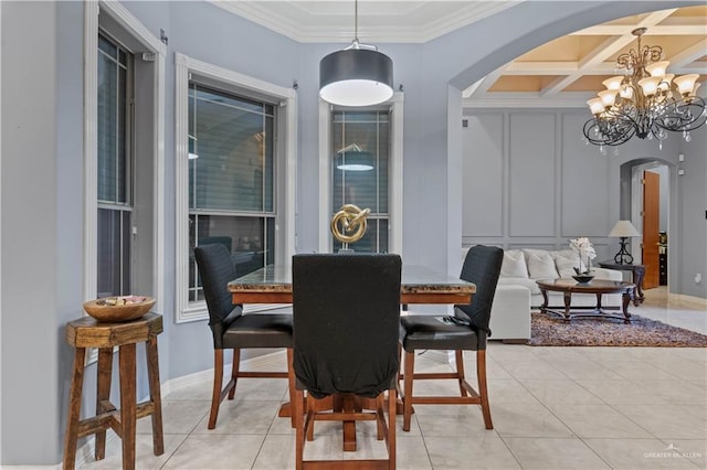 dining area featuring crown molding, beamed ceiling, arched walkways, a chandelier, and coffered ceiling
