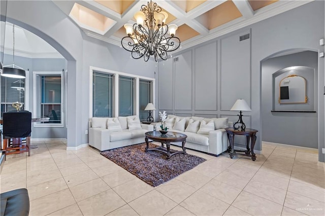 living room with visible vents, arched walkways, a decorative wall, ornamental molding, and a chandelier