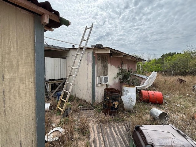 view of side of home featuring cooling unit