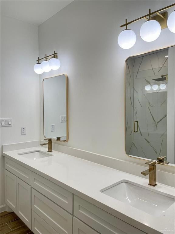 bathroom featuring hardwood / wood-style flooring, vanity, and walk in shower