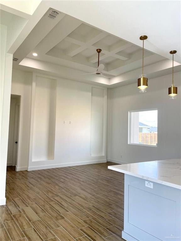 interior space featuring ceiling fan, coffered ceiling, beamed ceiling, and dark hardwood / wood-style floors