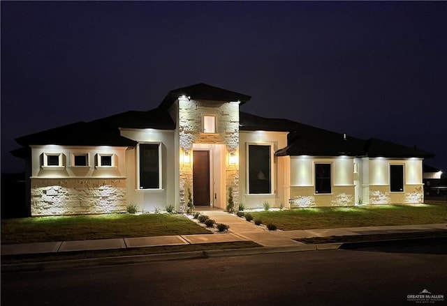 view of front of home with stone siding and stucco siding