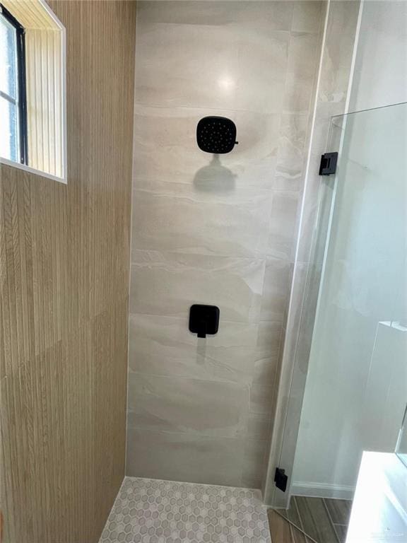 bathroom with a tile shower