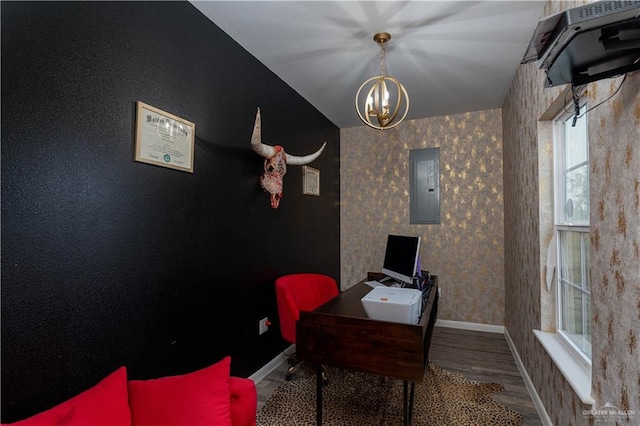 office area featuring hardwood / wood-style floors, a notable chandelier, lofted ceiling, and electric panel