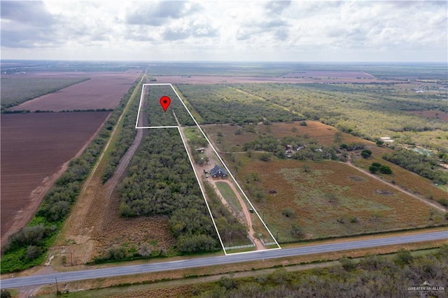 birds eye view of property featuring a water view and a rural view