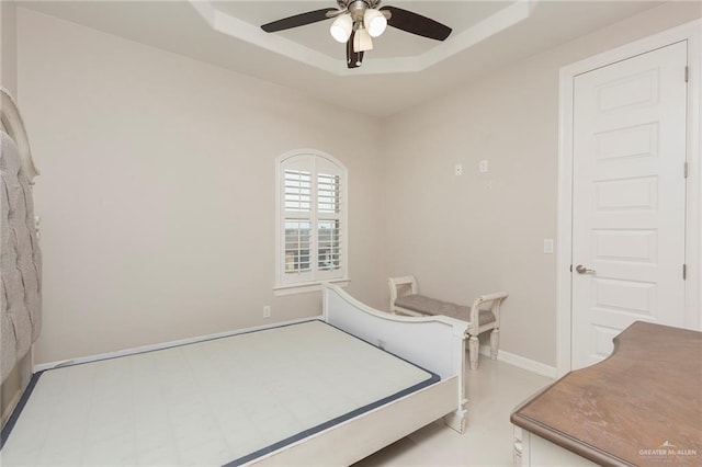 bedroom featuring a tray ceiling and ceiling fan