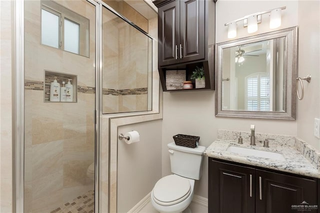 bathroom with vanity, toilet, walk in shower, and ceiling fan