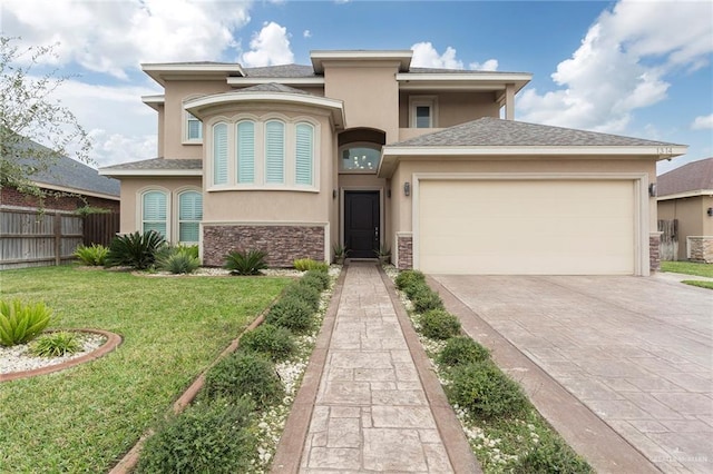 view of front of property with a garage and a front yard