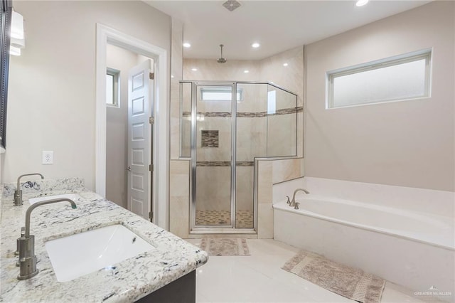 bathroom featuring tile patterned floors, plus walk in shower, and vanity