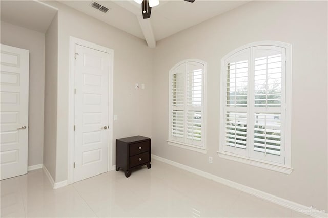 tiled bedroom featuring ceiling fan