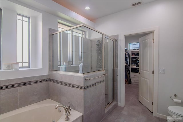 bathroom with tile patterned flooring, toilet, and independent shower and bath