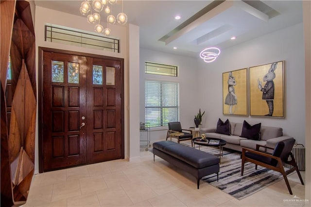 foyer featuring light tile patterned floors, radiator, and a chandelier