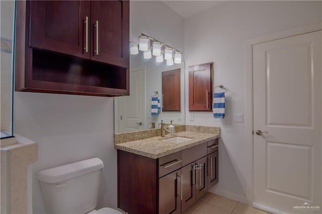 bathroom with tile patterned floors, vanity, and toilet