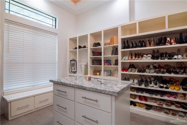 spacious closet with light tile patterned floors