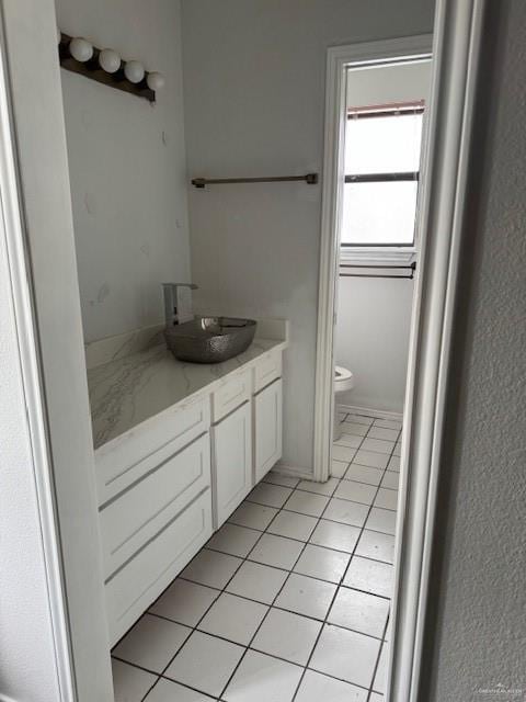 bathroom featuring tile patterned flooring, vanity, and toilet