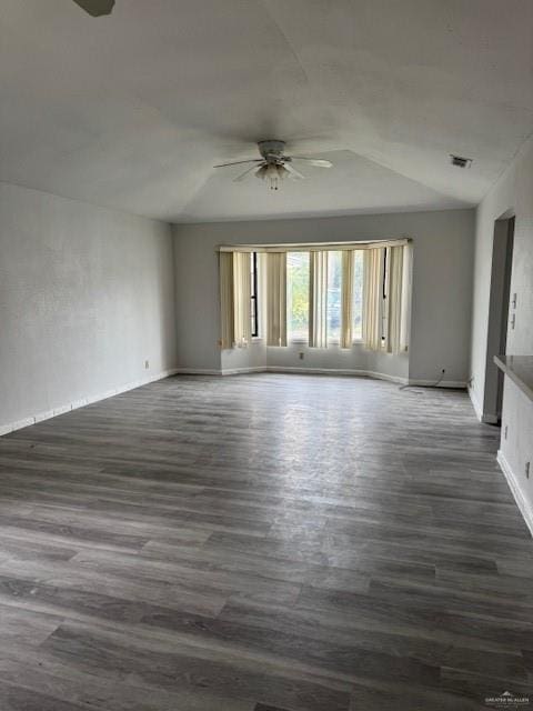 spare room with ceiling fan and dark hardwood / wood-style floors