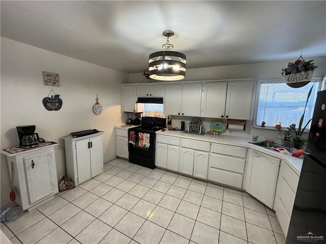 kitchen featuring black appliances, pendant lighting, white cabinetry, and light tile patterned floors