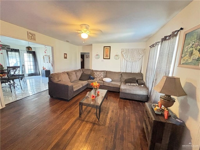 living room with ceiling fan and dark hardwood / wood-style flooring