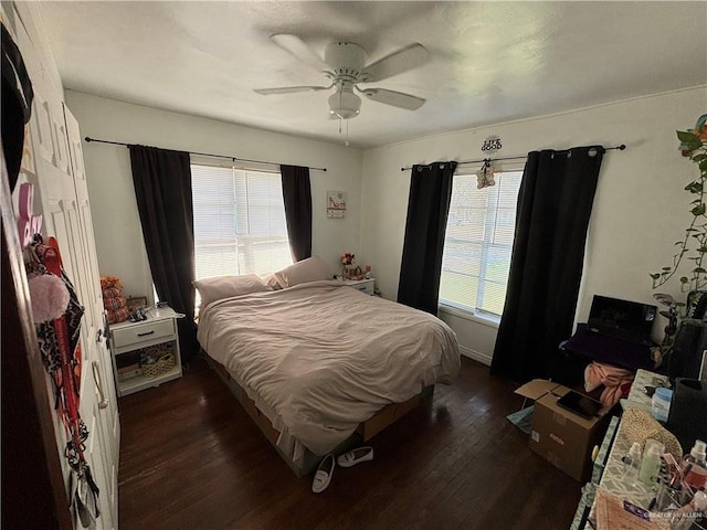 bedroom with ceiling fan and dark wood-type flooring