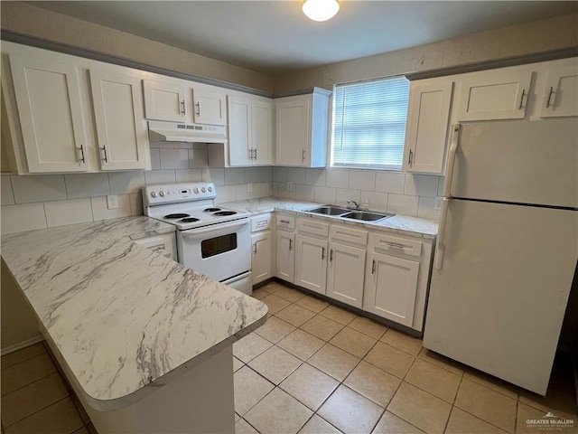 225 N 28th St, Mcallen, TX 78501 - kitchen with white appliances, under cabinet range hood, a sink, a peninsula, and white cabinetry