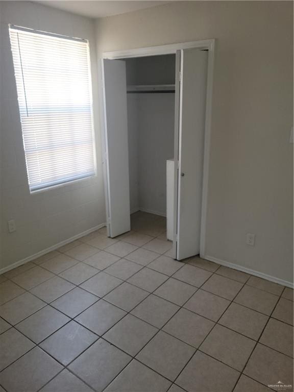 225 N 28th St, Mcallen, TX 78501 - unfurnished bedroom featuring a closet and light tile patterned floors