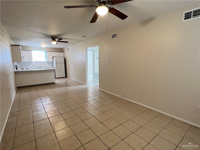 225 N 28th St, Mcallen, TX 78501 - unfurnished living room with light tile patterned floors, ceiling fan, and baseboards