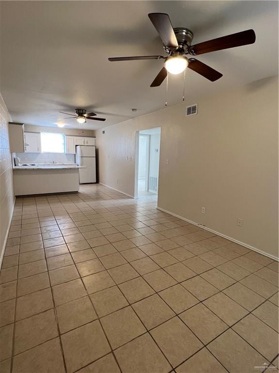 225 N 28th St, Mcallen, TX 78501 - unfurnished living room with light tile patterned flooring, a ceiling fan, and baseboards