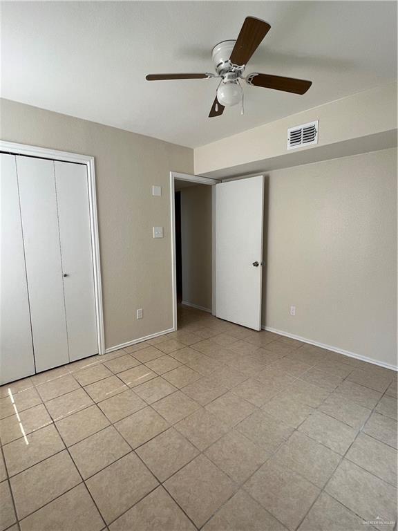 225 N 28th St, Mcallen, TX 78501 - unfurnished bedroom with a closet, baseboards, and ceiling fan