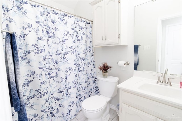 bathroom with a shower with shower curtain, vanity, toilet, and tile patterned floors