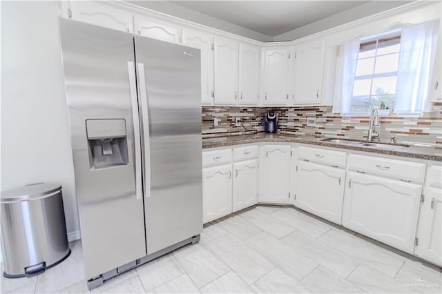 kitchen with a sink, white cabinetry, and stainless steel fridge with ice dispenser