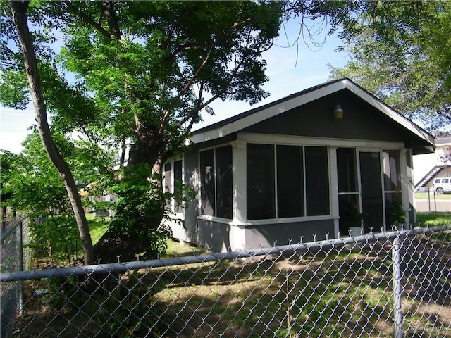 501 W Lovett St, Edinburg, TX 78541 - view of side of home featuring a sunroom and fence
