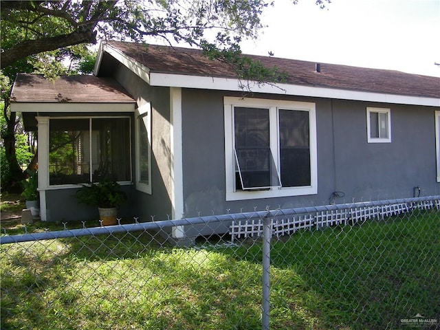 501 W Lovett St, Edinburg, TX 78541 - view of property exterior with fence, a shingled roof, and stucco siding