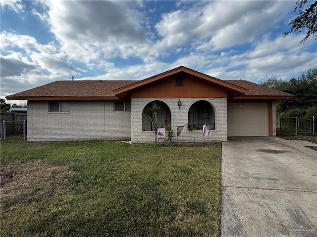 ranch-style home with a front lawn and a garage