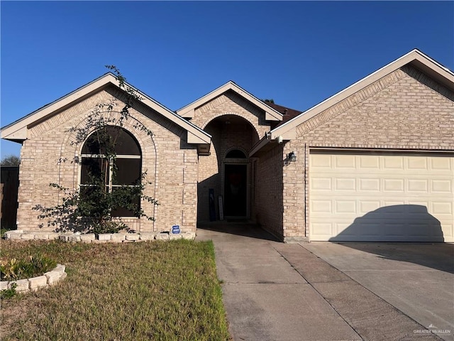 ranch-style house featuring a garage and a front lawn