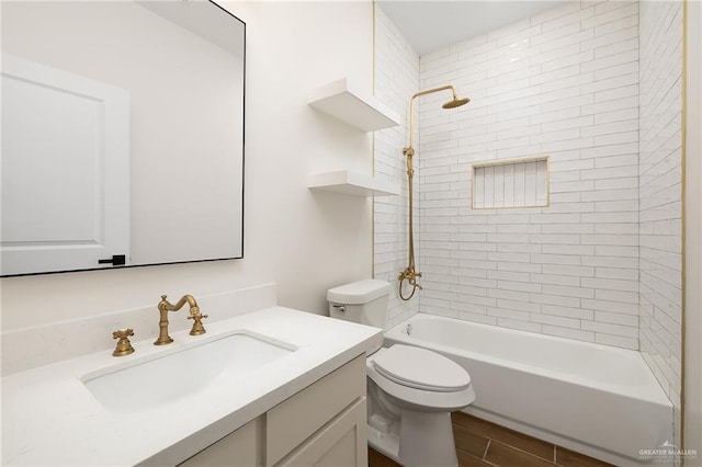 bathroom featuring toilet, vanity, and  shower combination