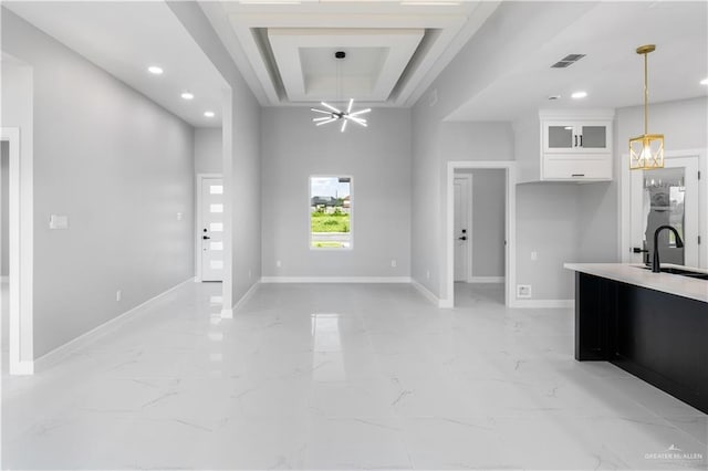 1326 S 9th St, Alamo, TX 78516 - kitchen featuring light marble finish flooring, white cabinetry, glass insert cabinets, decorative light fixtures, and a chandelier