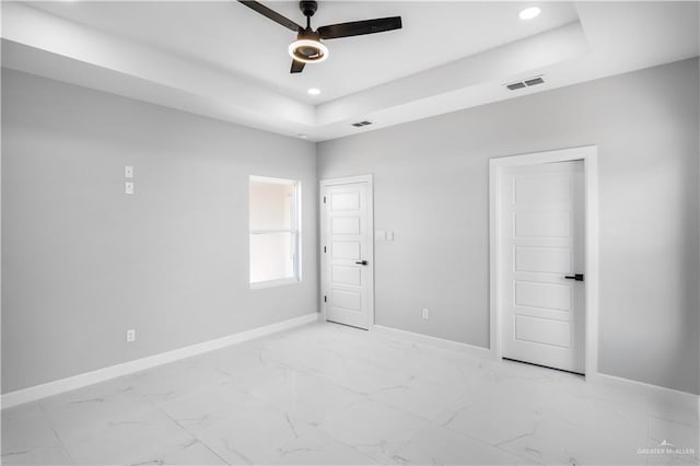 1326 S 9th St, Alamo, TX 78516 - unfurnished bedroom with baseboards, light marble finish floors, a raised ceiling, recessed lighting, and a ceiling fan