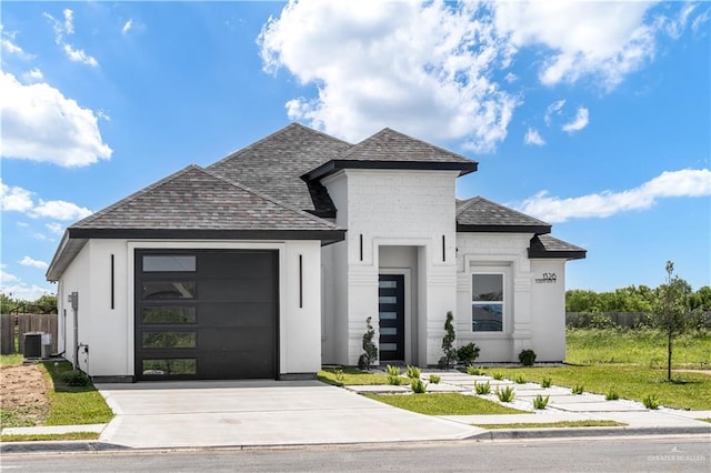1326 S 9th St, Alamo, TX 78516 - view of front of house featuring a garage, driveway, fence, a shingled roof, and central air condition unit