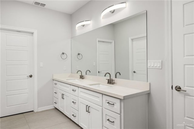 full bath featuring visible vents, a sink, baseboards, and double vanity