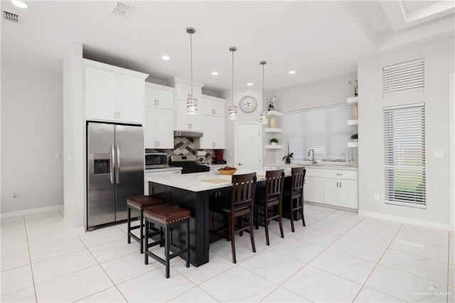 kitchen with open shelves, decorative backsplash, a kitchen island, under cabinet range hood, and stainless steel appliances