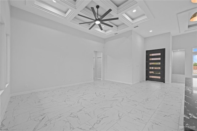 unfurnished room with marble finish floor, a high ceiling, and baseboards